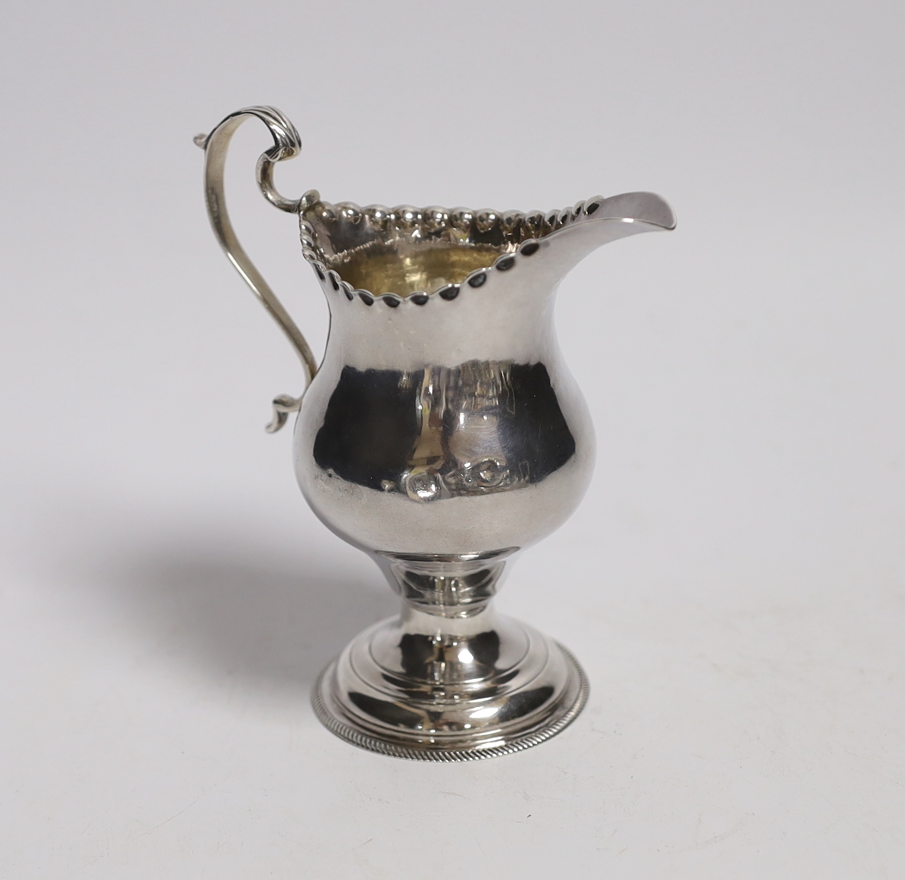 A George III silver inverted pear shaped cream jug, by Hester Bateman, London, 1775, 11.3cm.